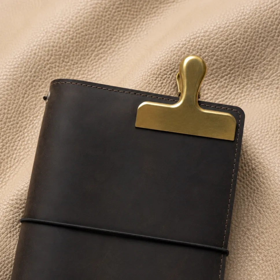Gold nameplate bookmark clip for leather journals — open view