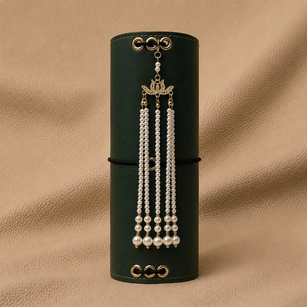 Decorative journal charm attached to elastic band of leather notebook cover