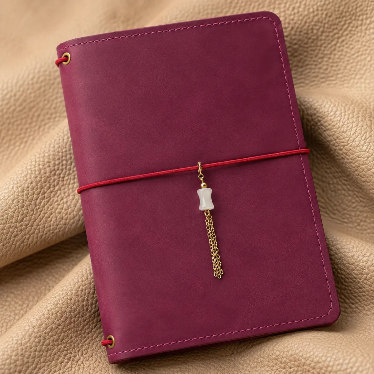 Elegant beaded charm hanging from a notebook as a beautiful decorative accessory.
