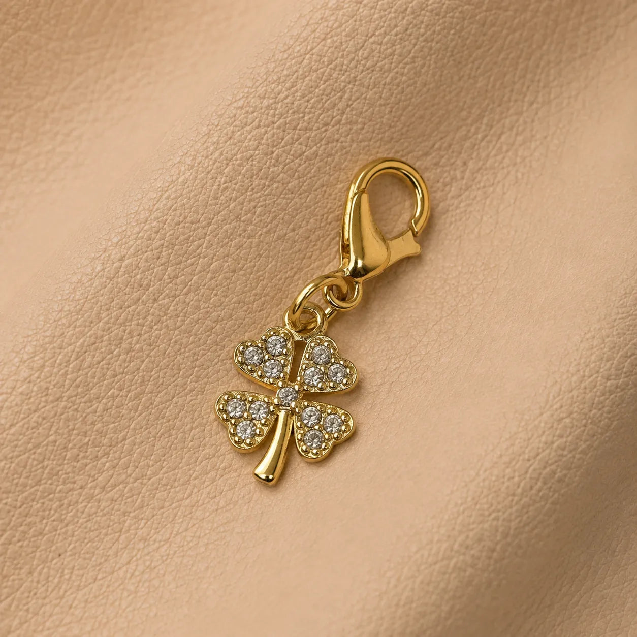 Clover journal charm attached to notebook elastic bands, elegant decorative planner accessory.