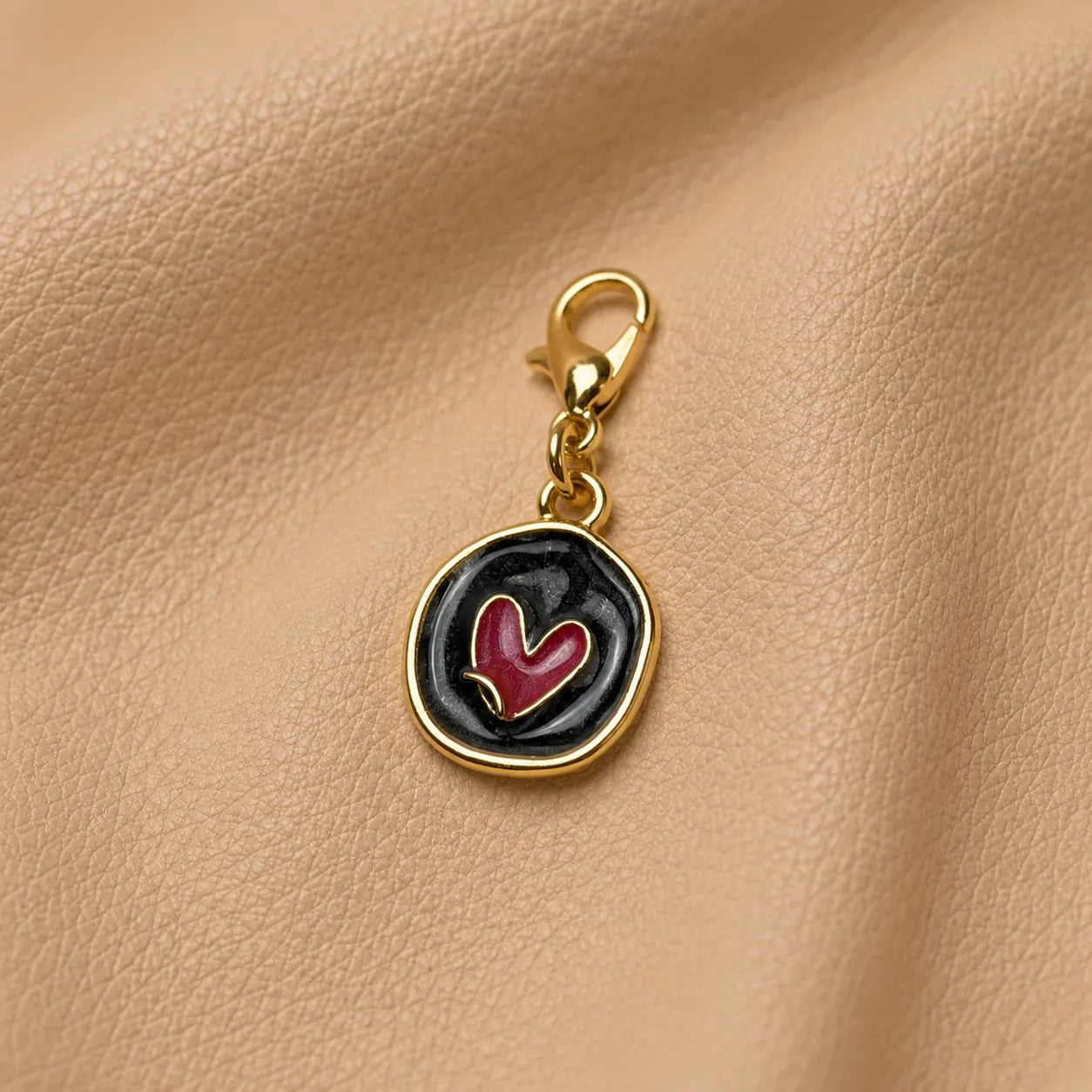 Metal journal charm with a cup-shaped bead and heart detail for notebook decoration.