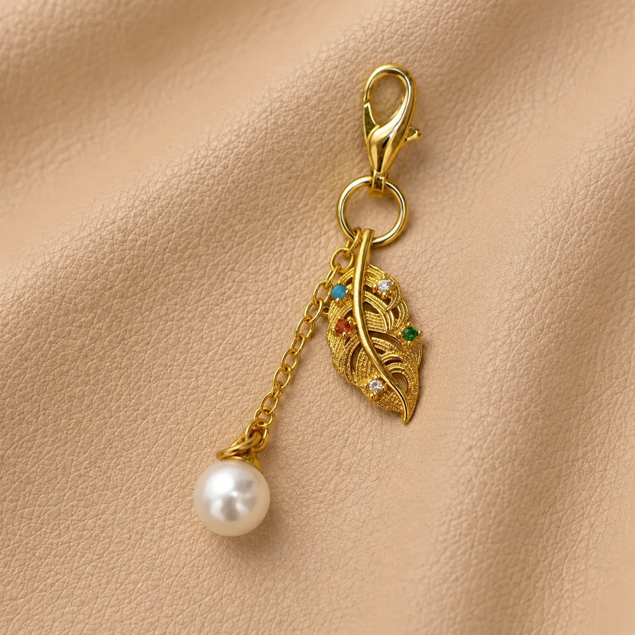 Decorative leaf notebook charm hanging from elastic closure, stylish journal accessory for planners.