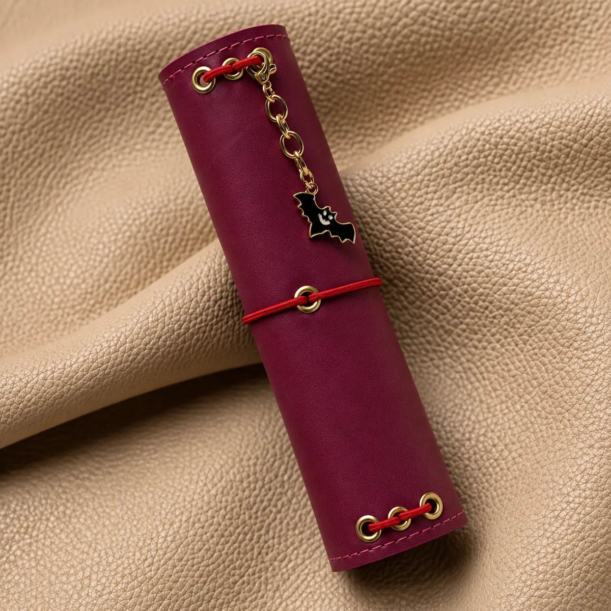 Small charm attached to a notebook elastic, adding a graceful decorative accent.