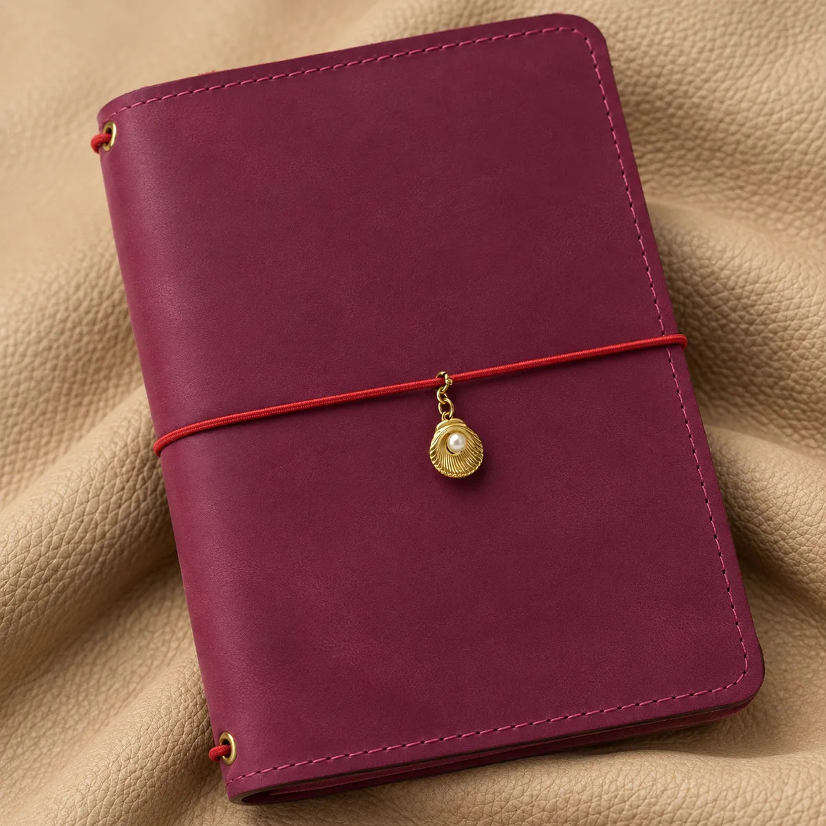 Decorative bead charm clipped onto a notebook elastic for a beautiful personalized appearance.