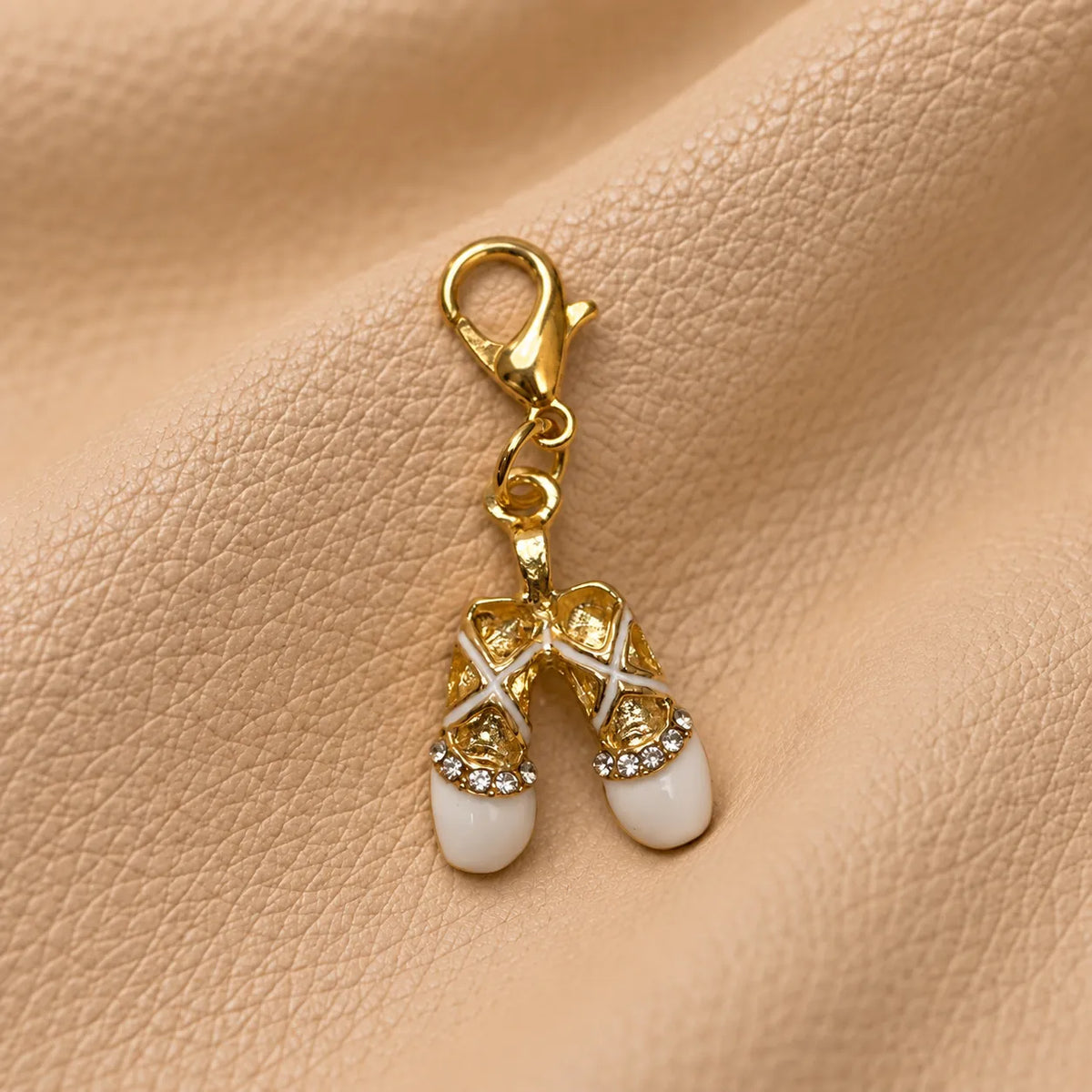 Delicate journal charm attached to a notebook elastic, adding a lovely decorative finishing touch.