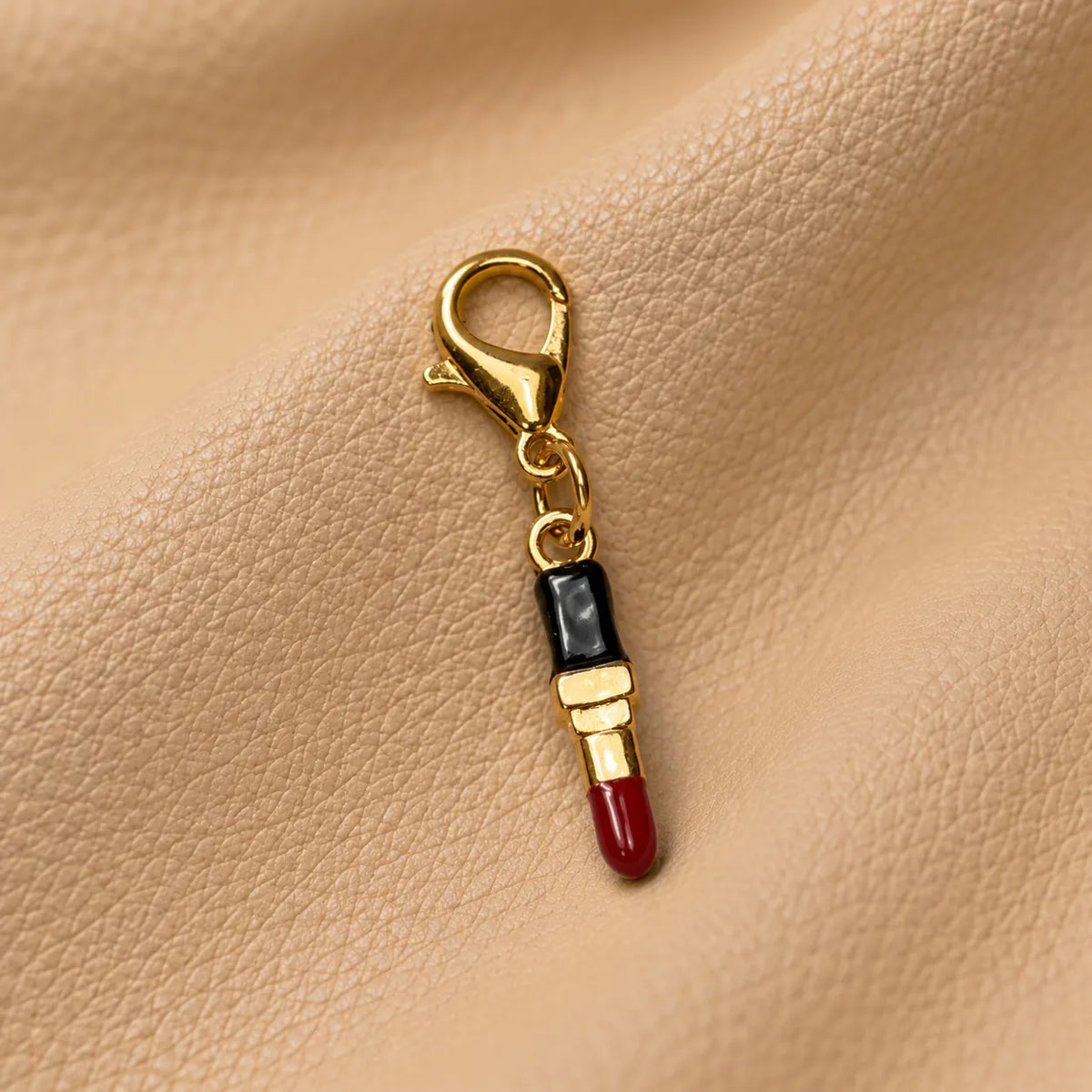 Delicate charm accessory hanging from a journal elastic for a stylish appearance.