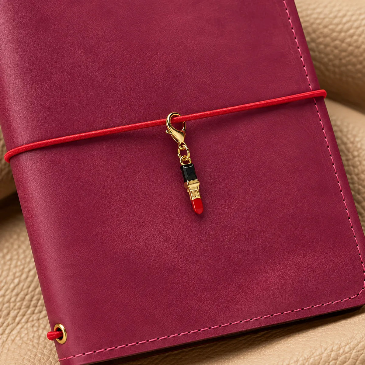 Beaded journal charm adding an elegant decorative touch to a leather notebook.