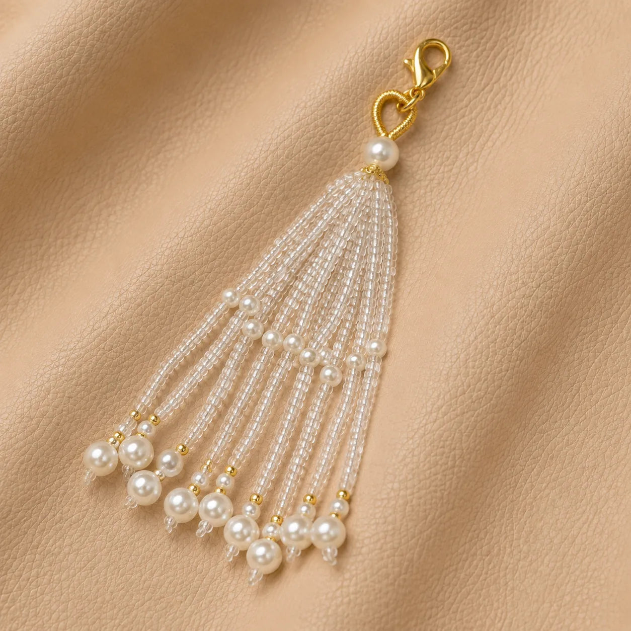 Beaded notebook charm with metal clasp displayed close-up, stylish accessory for travel journals.