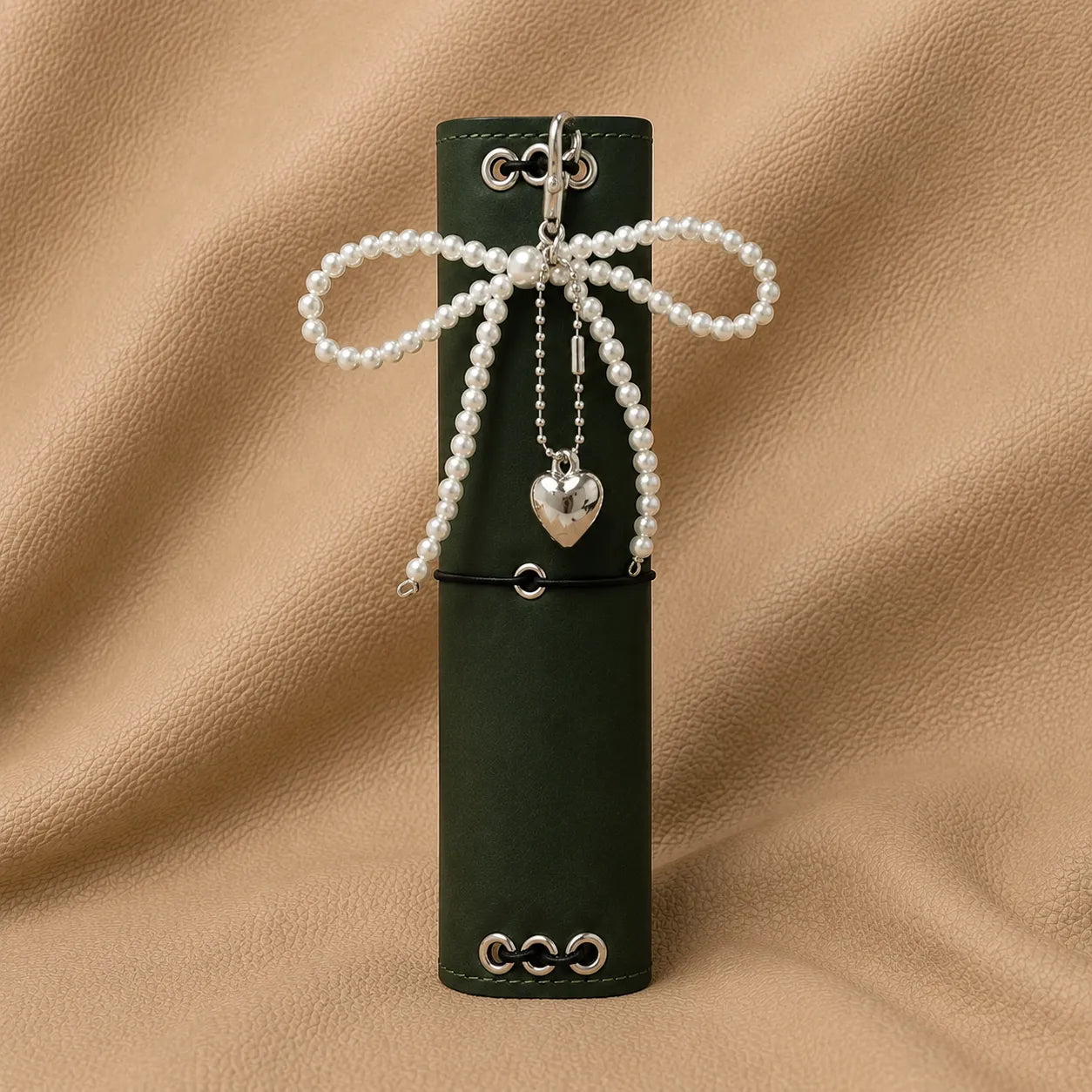 Beaded bow journal charm attached to elastic notebook cover accessory.
