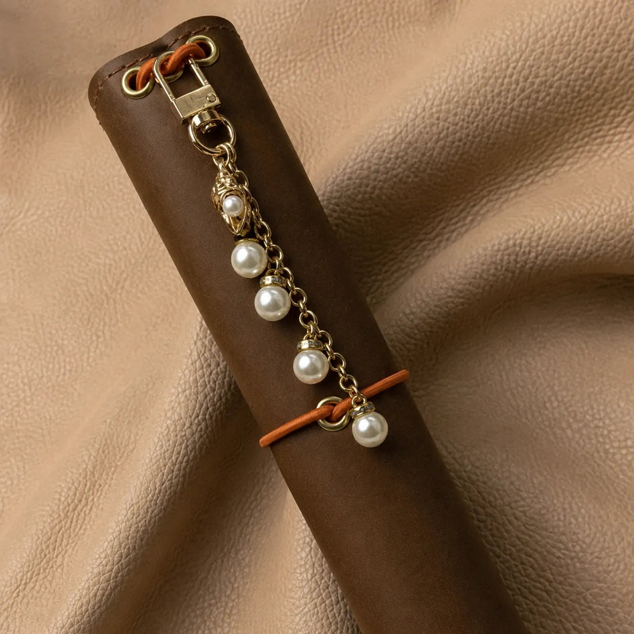 Handmade journal charm with decorative beads attached to elastic notebook closure for elegant personalization