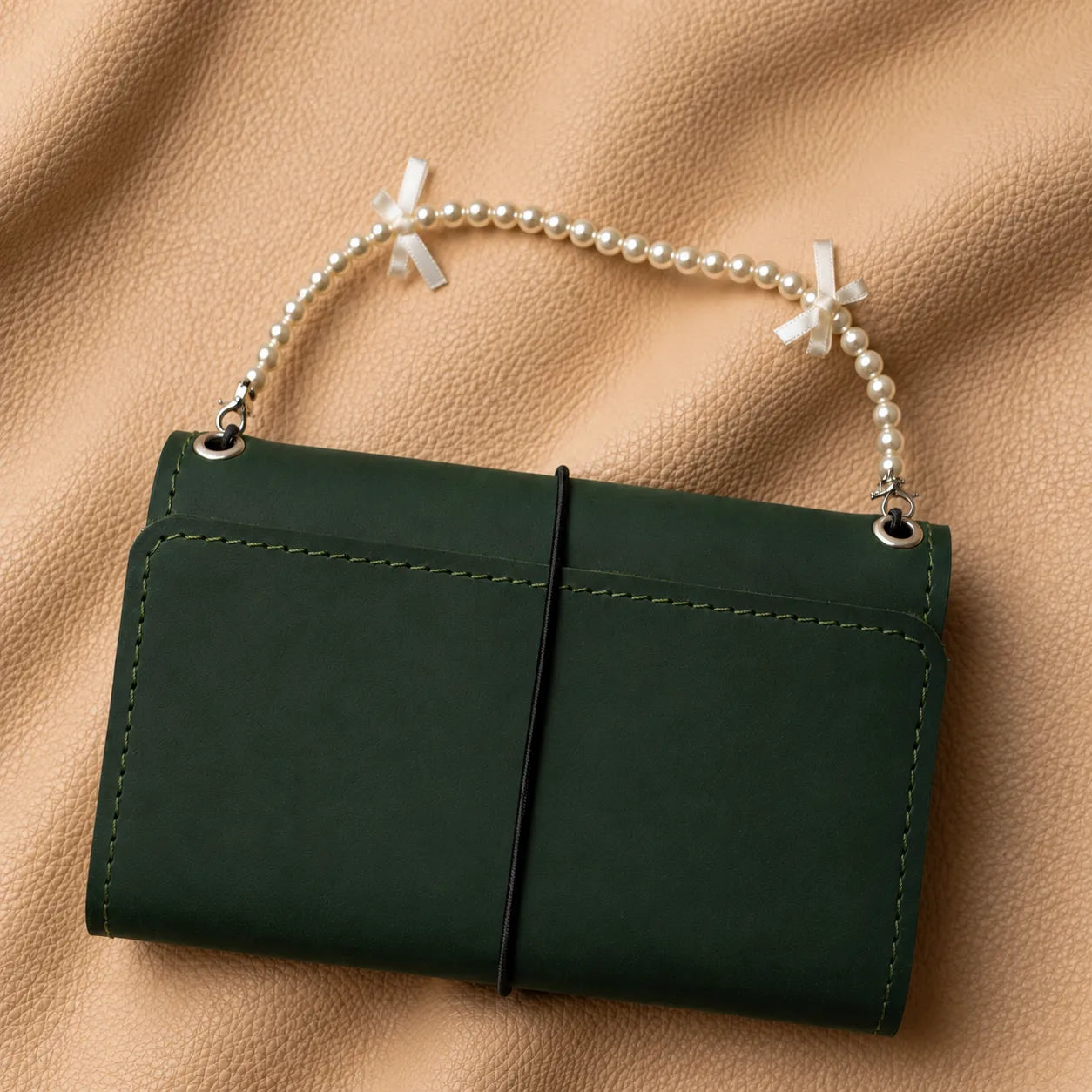 Decorative beaded journal handle charm with metal clasp for traveler's notebook.