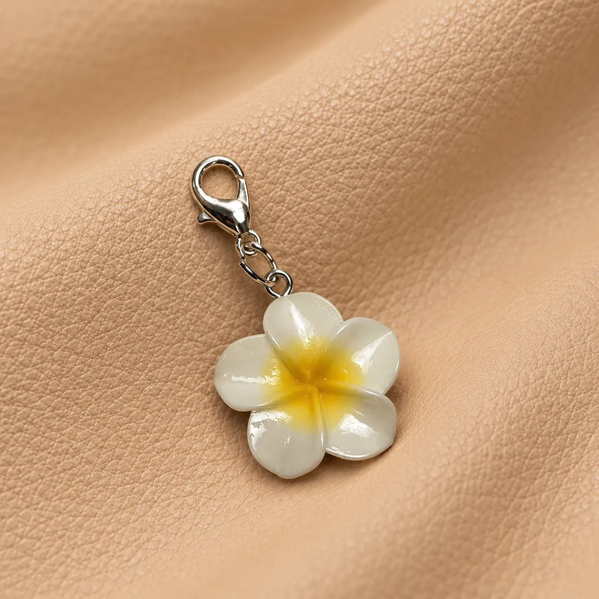 Stylish journal charm featuring a bead and hanging chains attached to an elastic band.