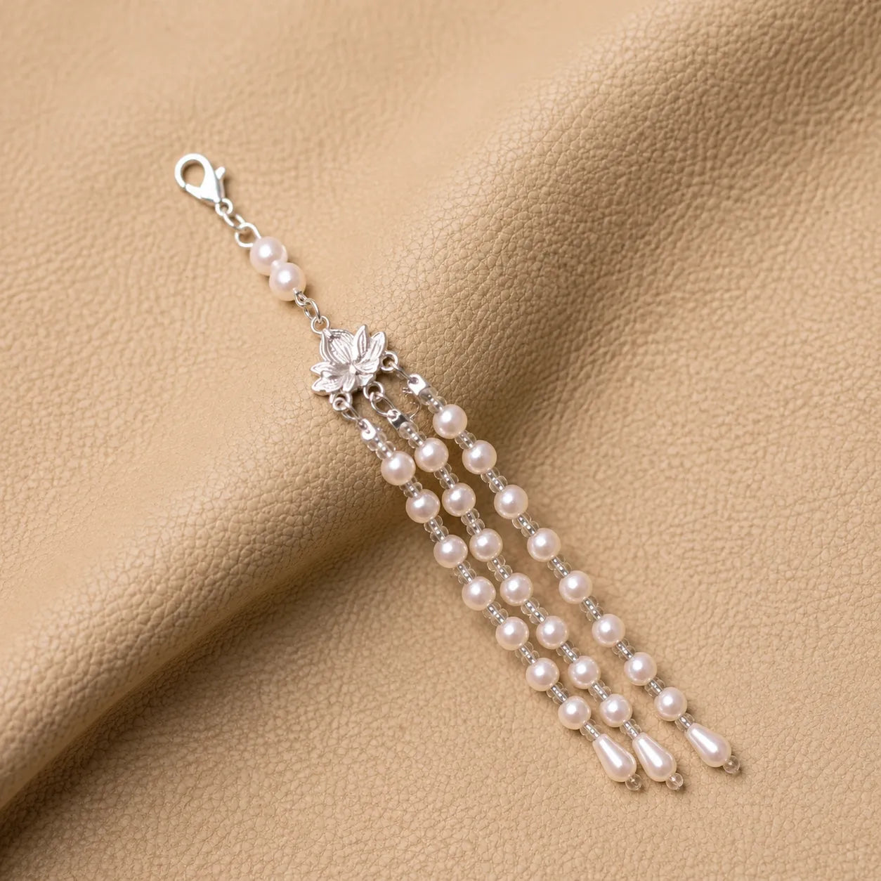 Beaded journal charm attached to leather notebook elastic band accessory