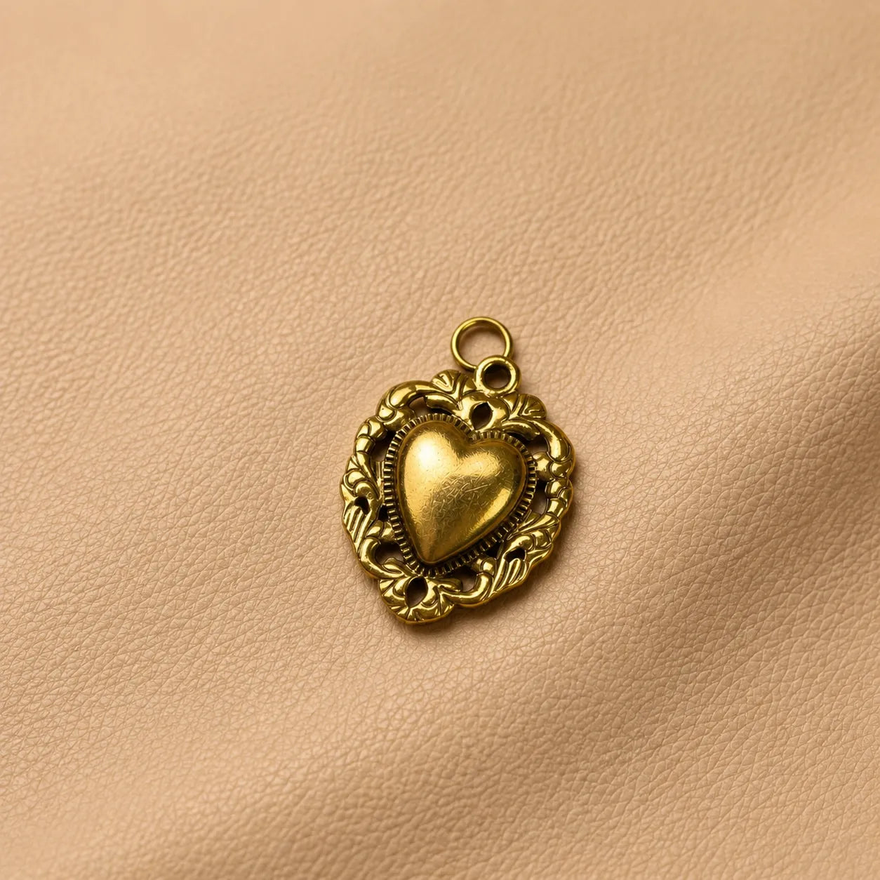 Cute heart journal charm decorating refillable leather notebook with secure metal clip attachment.
