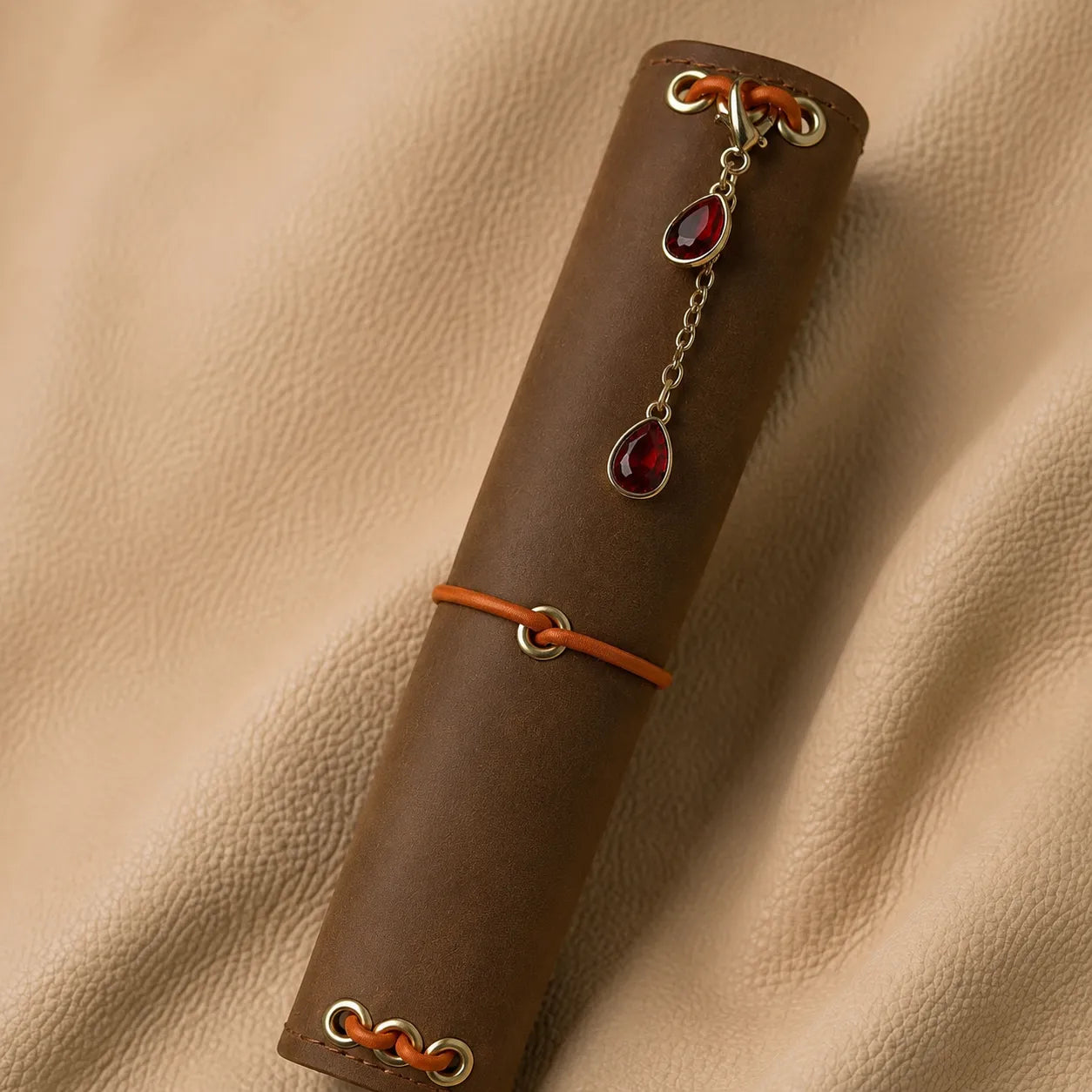 Decorative gemstone journal charm accessory for leather notebooks with secure elastic attachment.