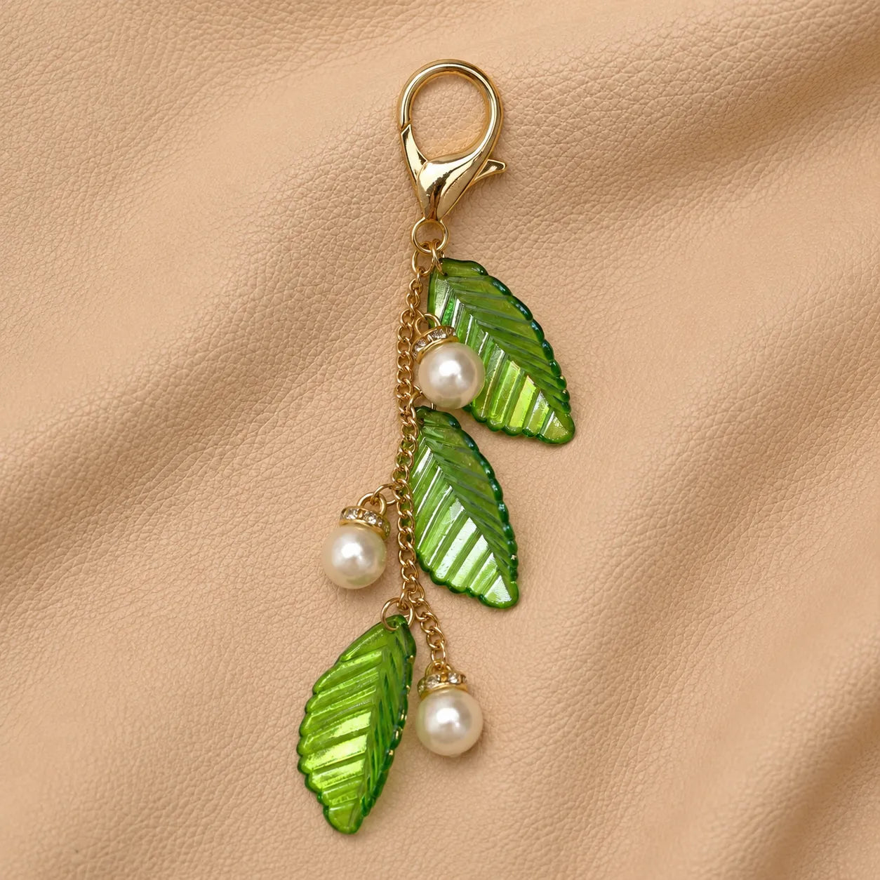 Leaf journal charm attached to elastic notebook bands, elegant botanical accessory for planners and journals.