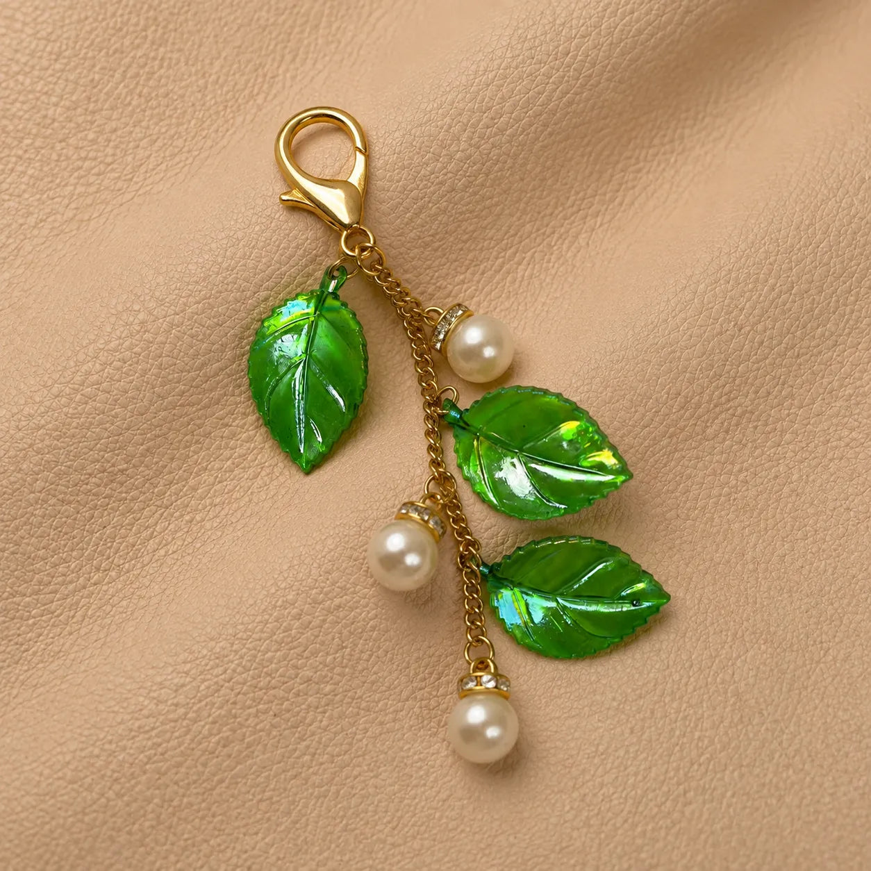 Journal charm with delicate leaf pendant attached to an elastic notebook band.