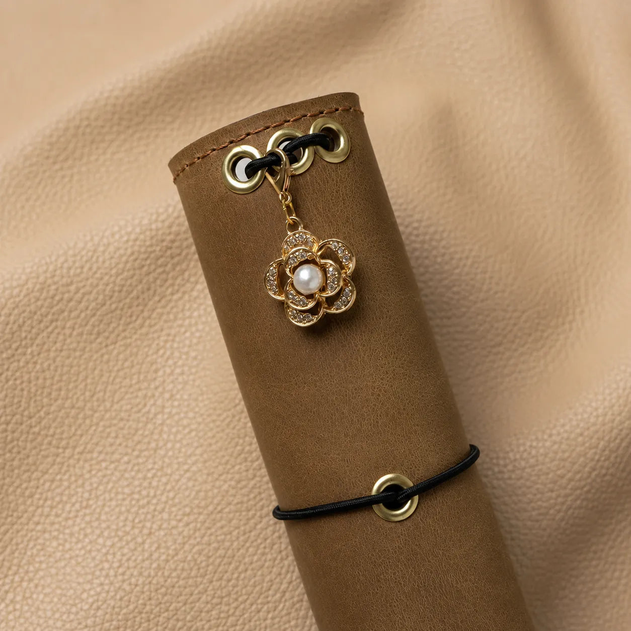 Decorative floral notebook charm with a flower bead for journal personalization.