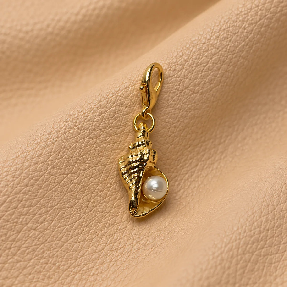Delicate journal accessory featuring a decorative bead attached to an elastic closure.