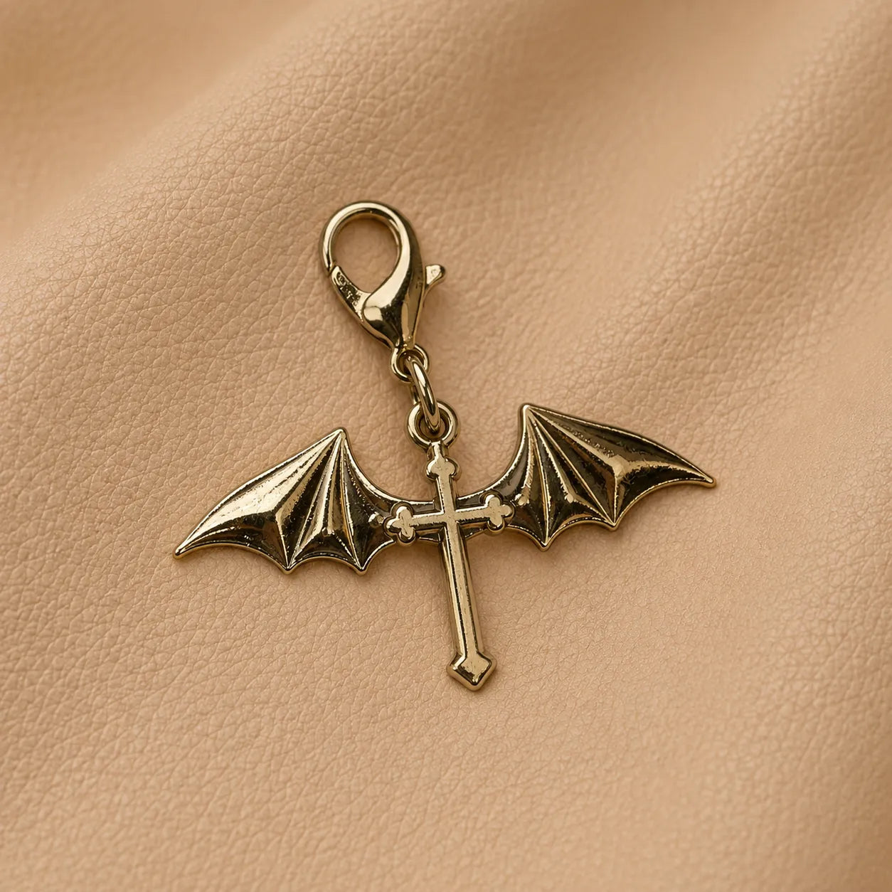 Gold winged cross journal charm attached to notebook elastic band, elegant handcrafted accessory