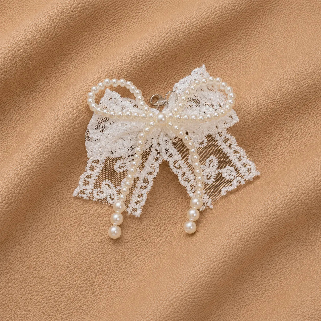 Delicate lace bow journal charm with pearl beads and metal clip.