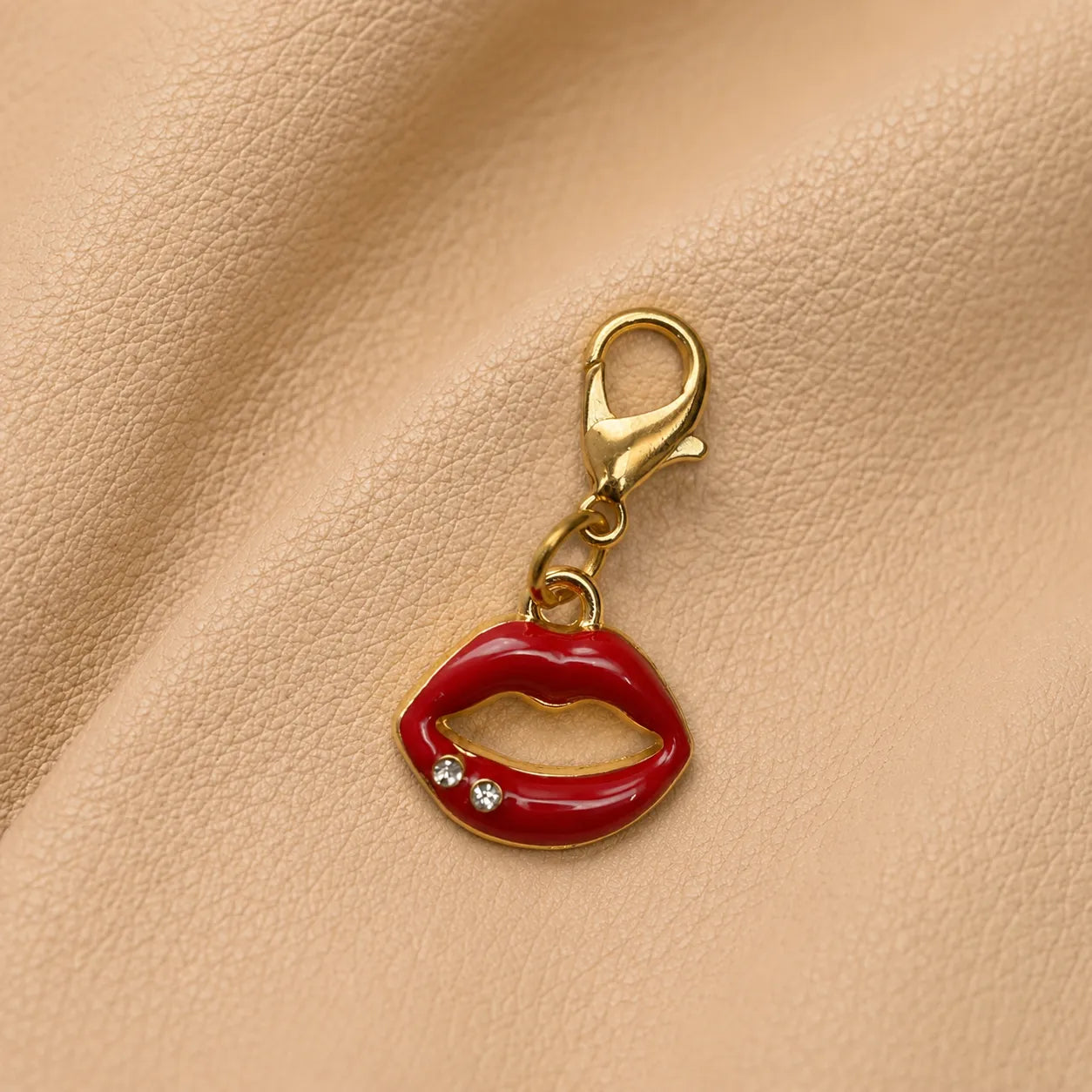 Metal lips journal charm decorating elastic notebook closure, elegant accessory for refillable leather journal.