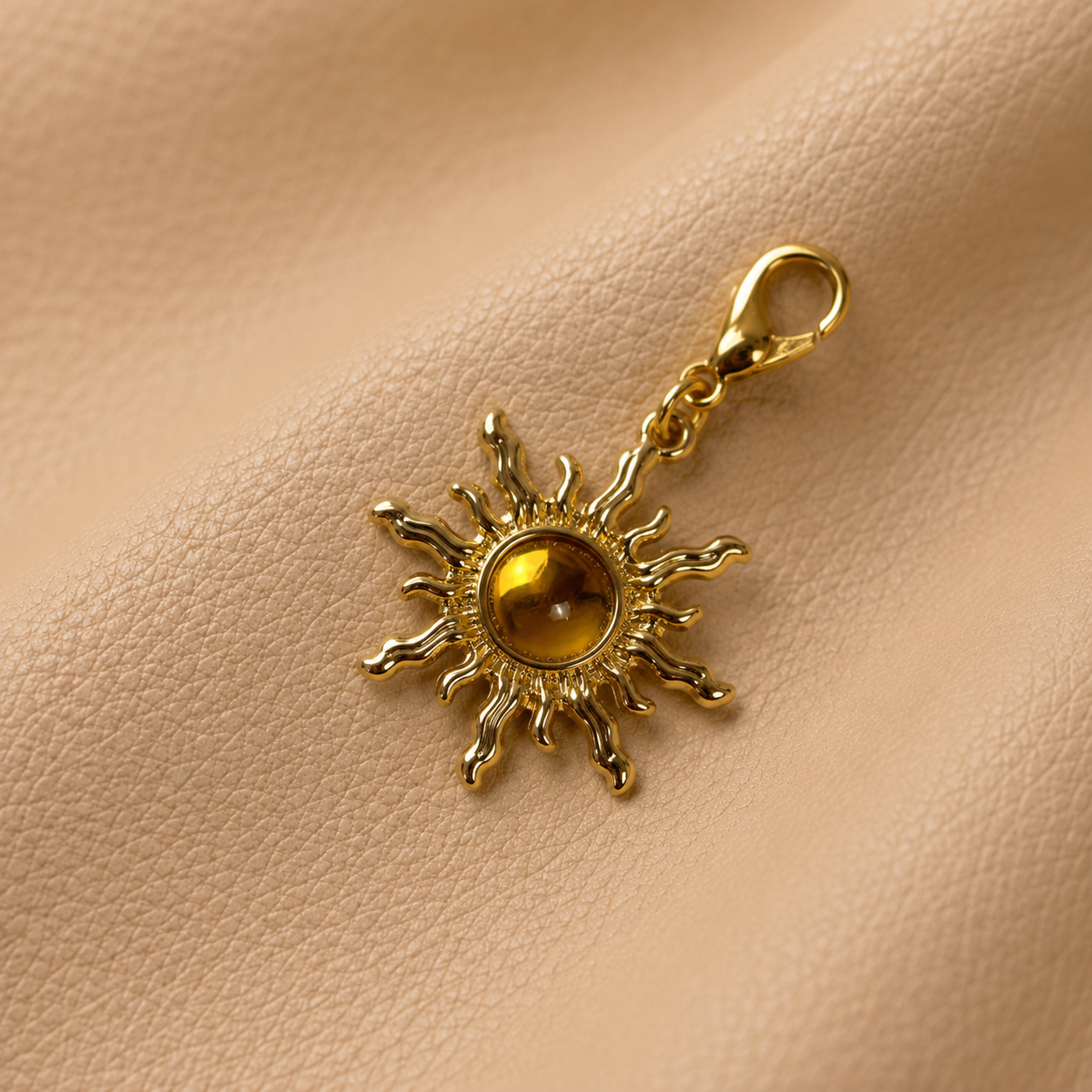Metal sun charm with a black stone, elegant notebook accessory for journal elastic bands.