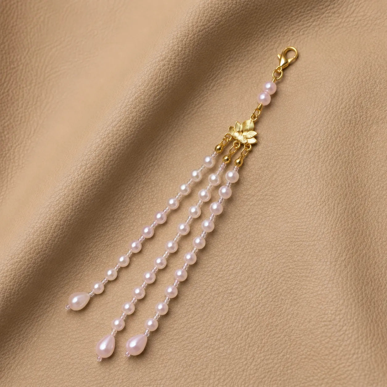 Handcrafted beaded journal charm attached to elastic notebook cover band accessory
