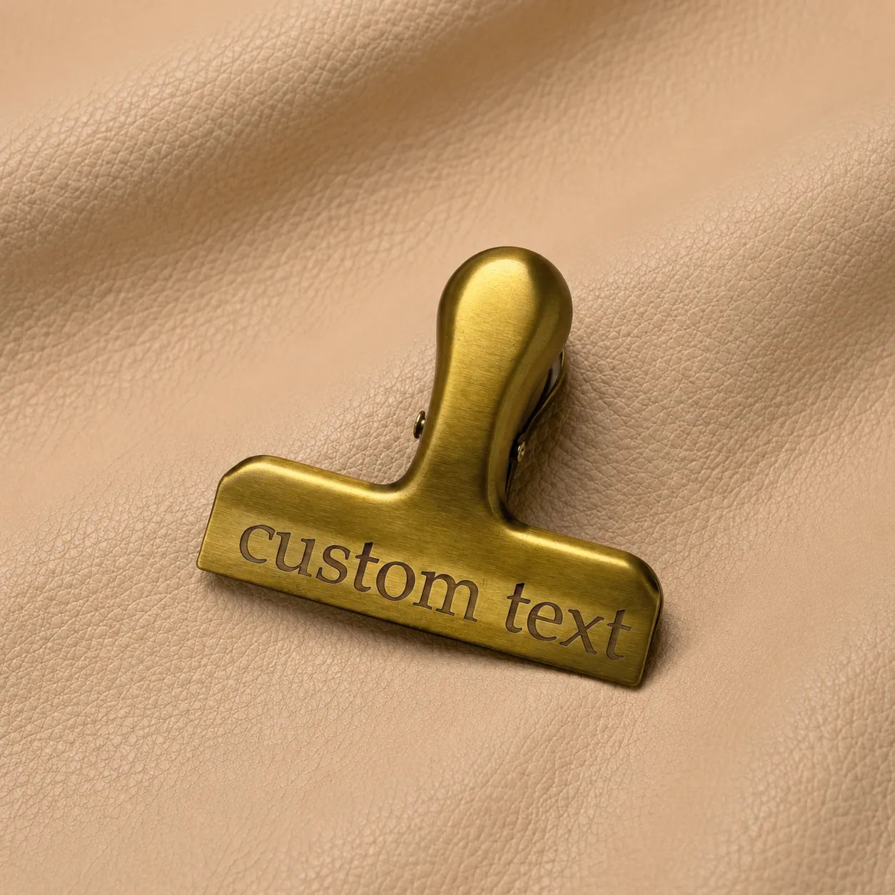 Elegant engraved gold bookmark clip securely marking pages in a notebook for quick access.