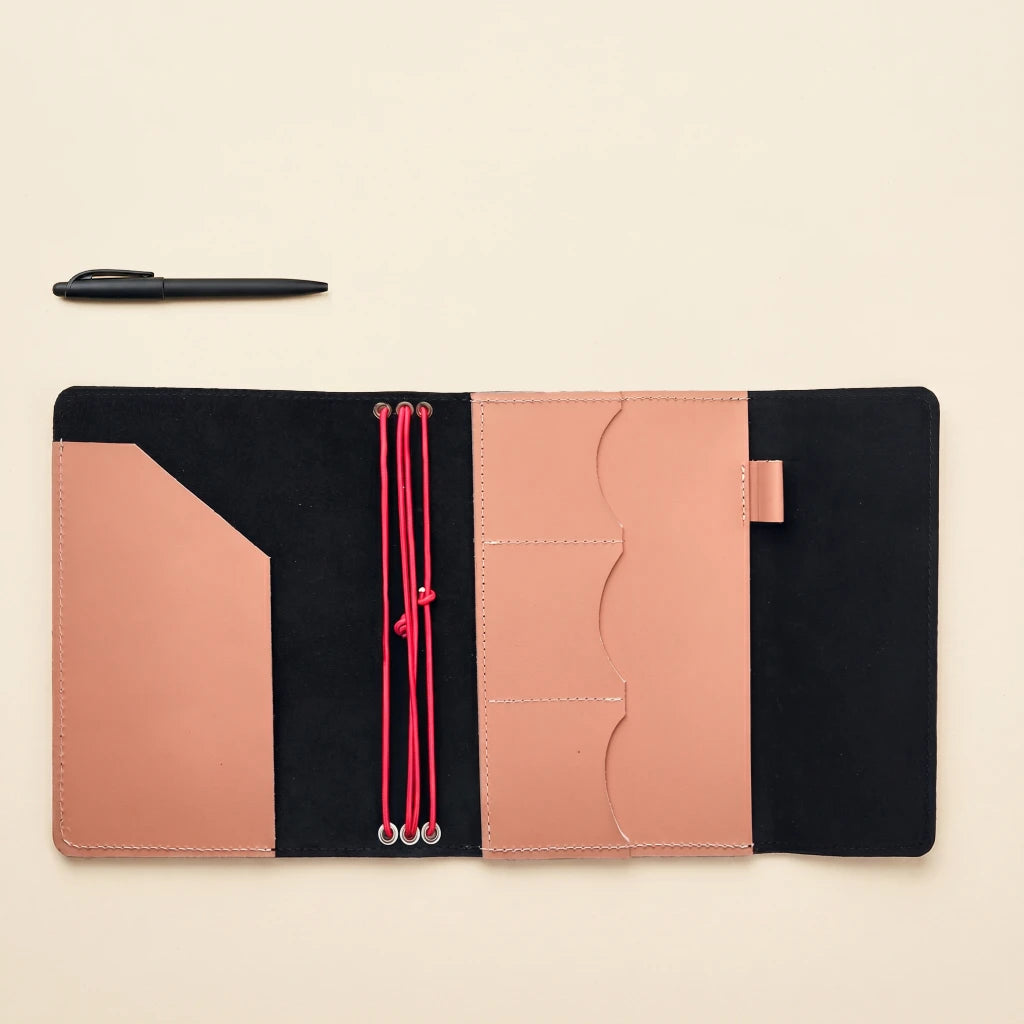 Leather notebook portfolio cover with elastic straps and organized inner design