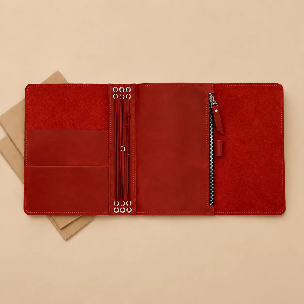Red genuine leather notebook cover with six elastic bands, pockets, zipper pocket, and pen loop.