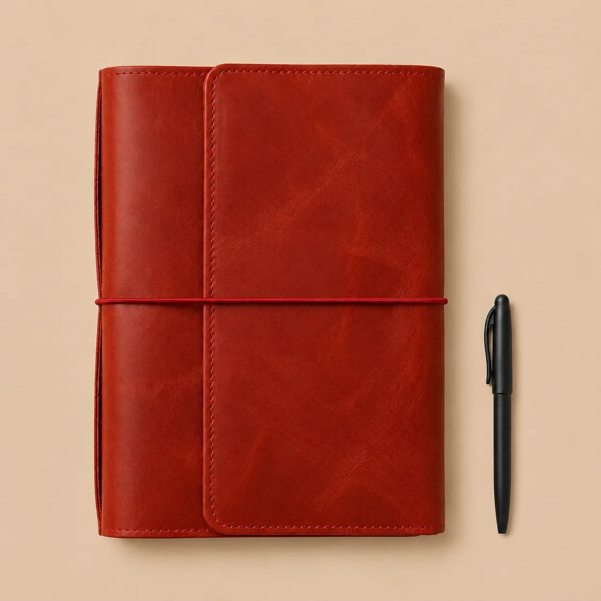 Red leather journal cover with six elastic bands, practical pockets, zippered compartment, and pen holder.