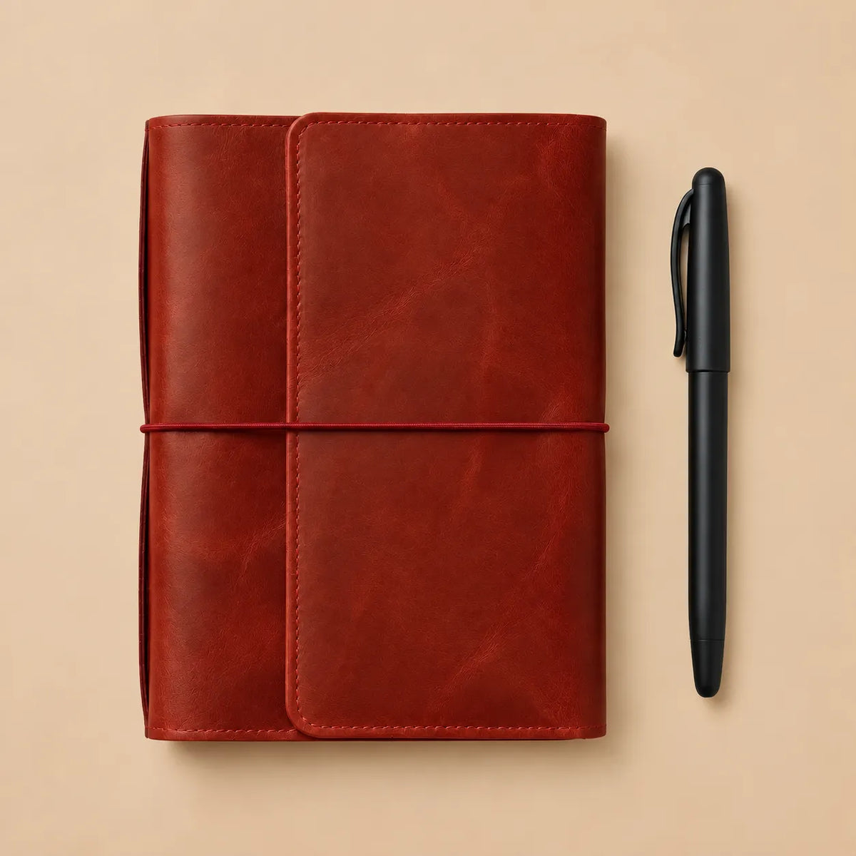 Handmade leather notebook cover in red with six elastic bands, pockets, zipper compartment, and pen loop.