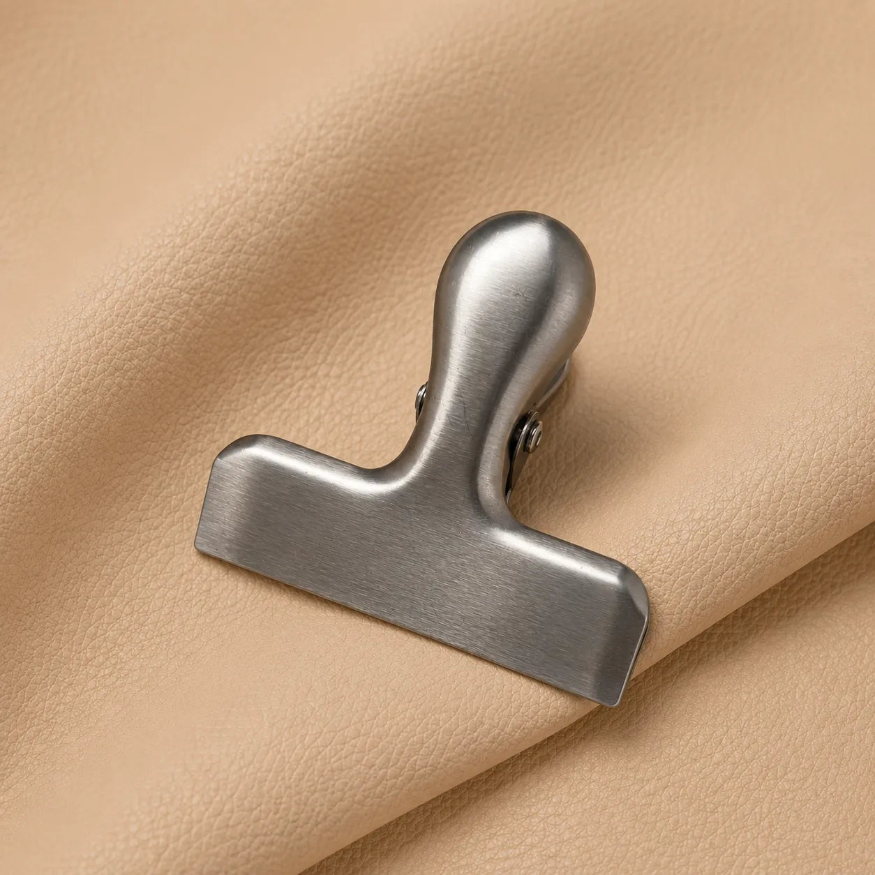 Minimalist silver page clip bookmark compatible with journals, planners, and notebooks of all sizes.