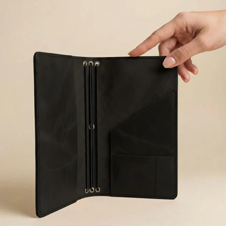 Black leather wallet with a brown cardholder and a small pouch on a beige background