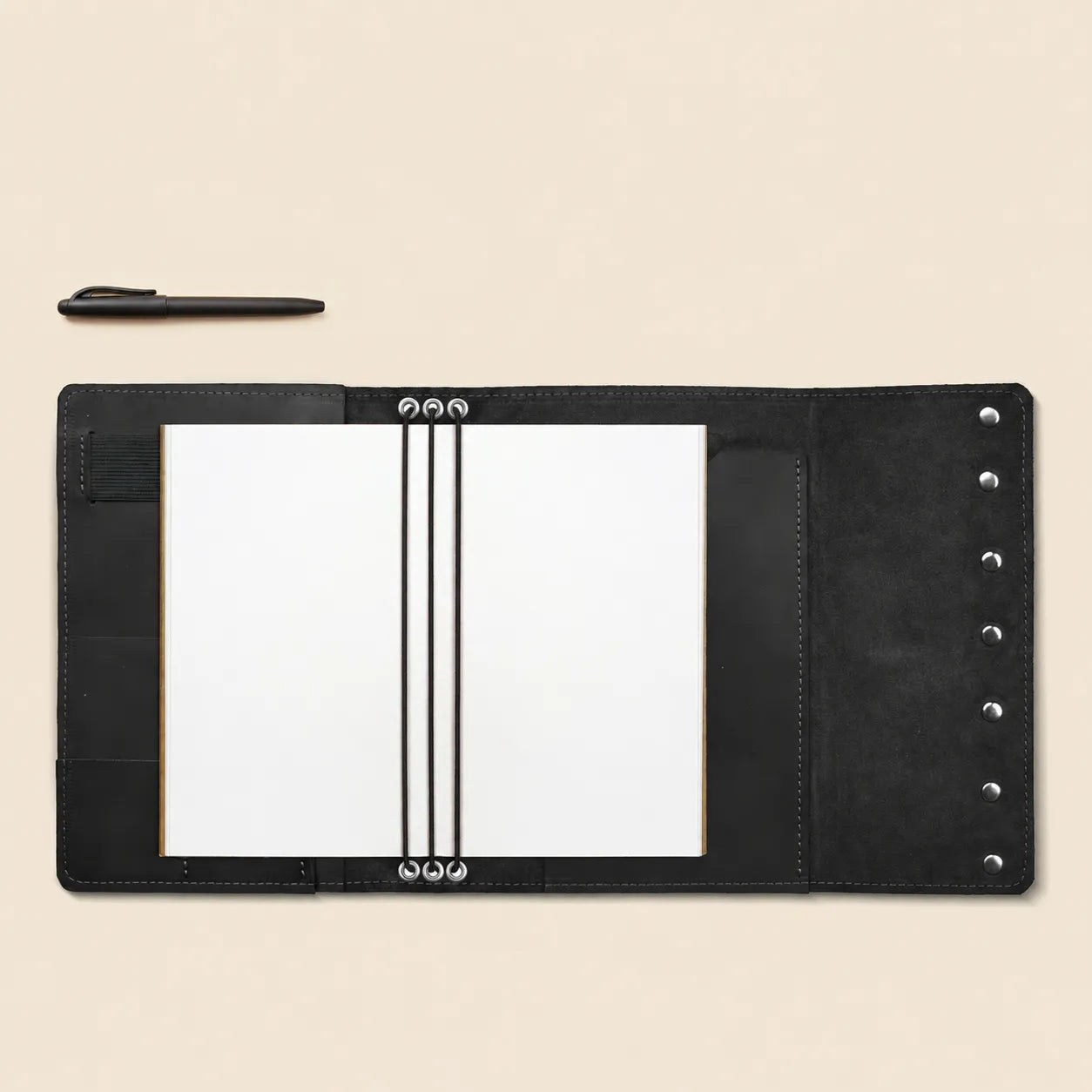 Elegant leather notebook case with card pockets and convenient pen holder.