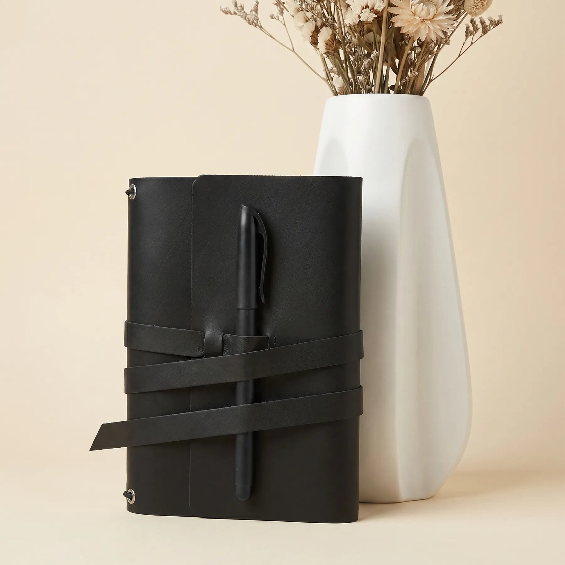 Leather notebook cover with practical pen storage and beautifully finished natural leather surface.