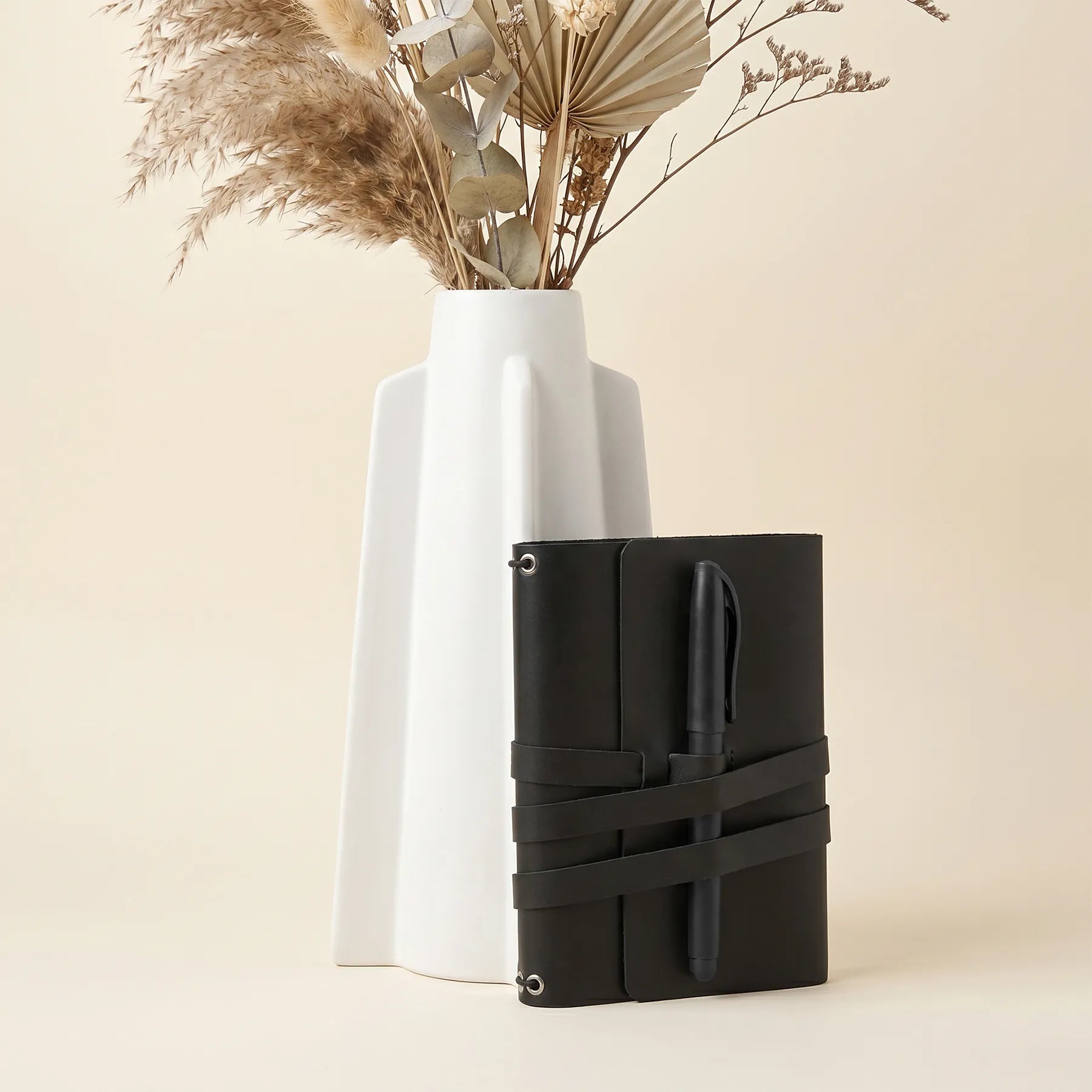 Durable genuine leather notebook cover designed with pen holders and refined handmade finish.