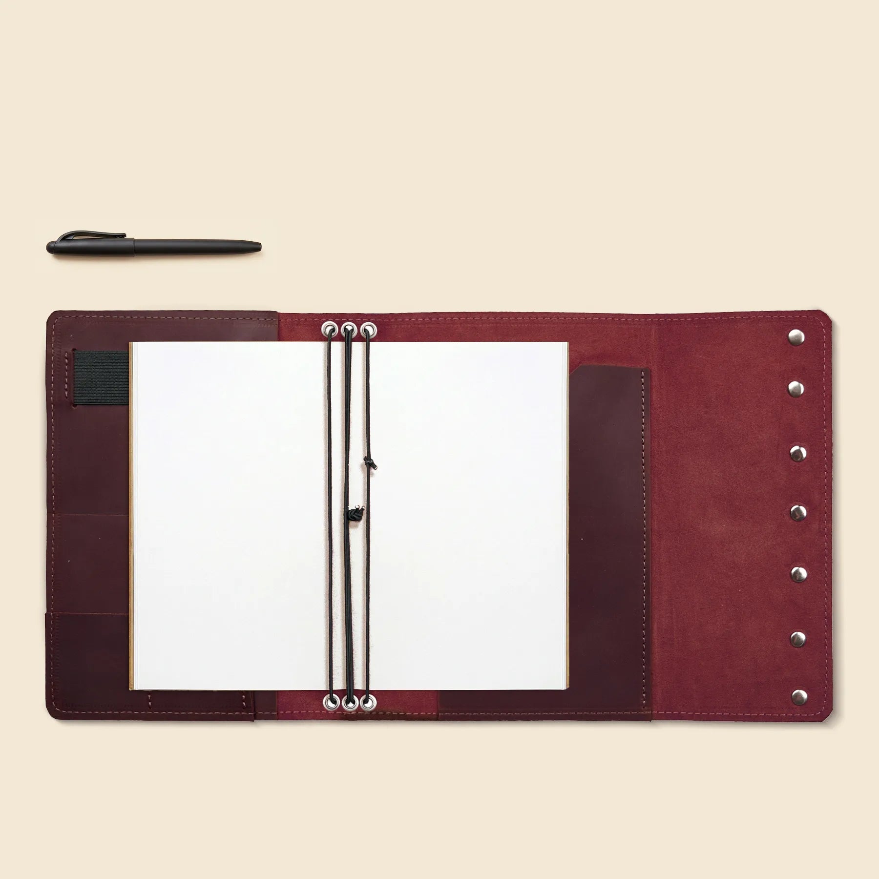Refillable leather journal case featuring three bands and organizer pockets.