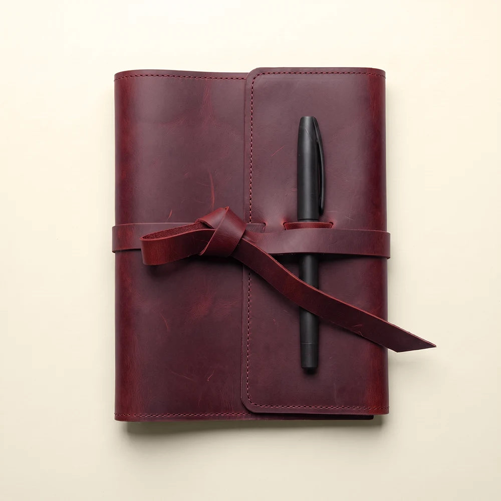 Genuine leather notebook organizer featuring card pockets and attached pen loop.