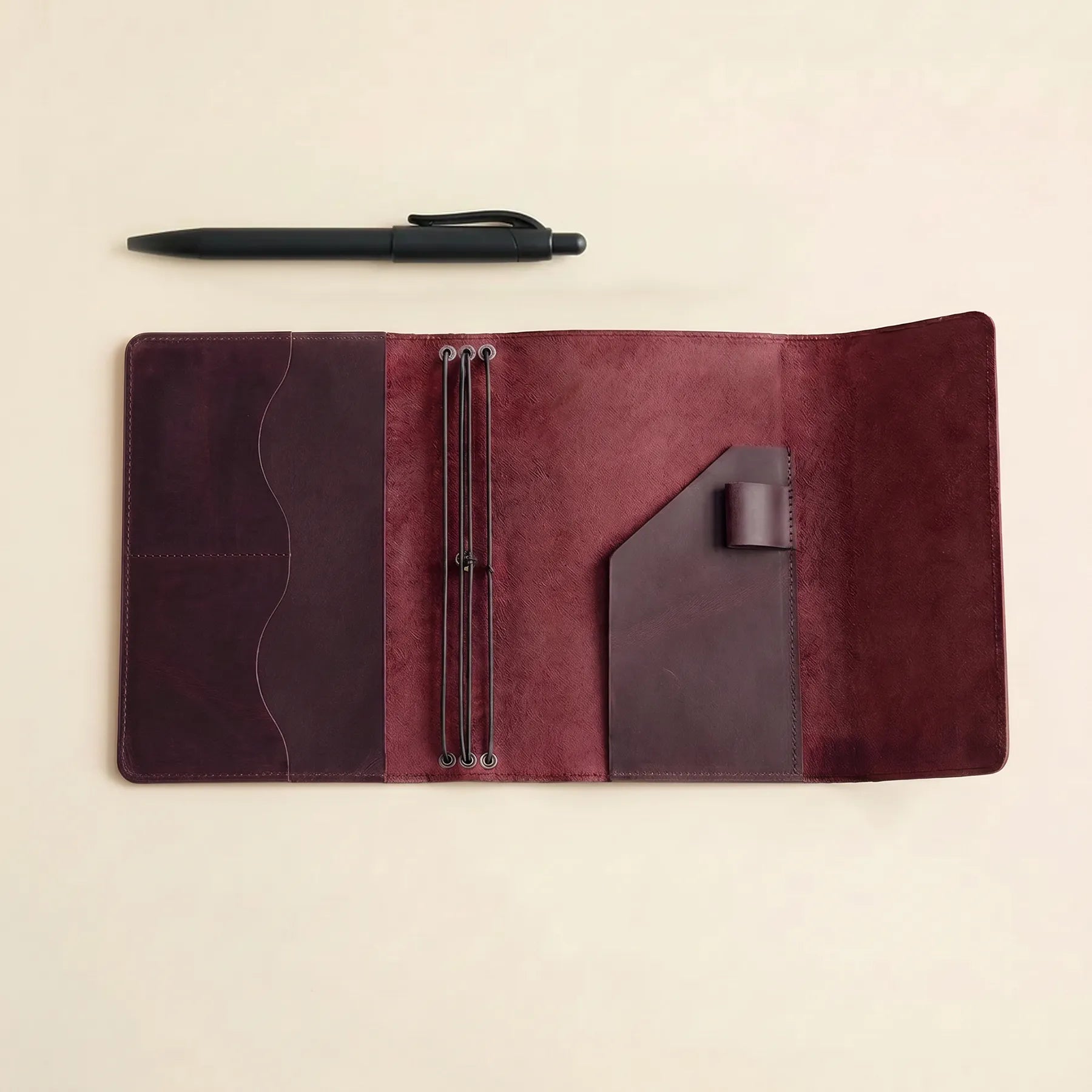 Leather journal cover with refillable inserts and organized interior pockets.