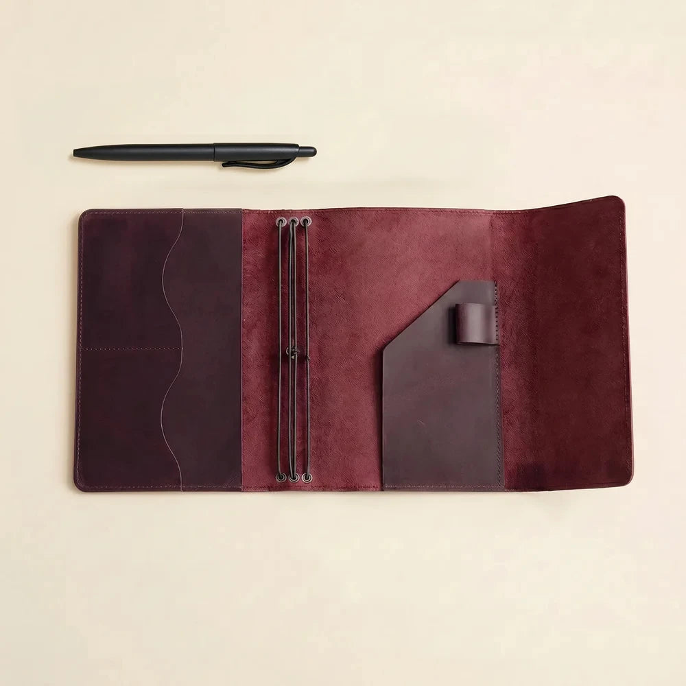 Genuine leather notebook sleeve featuring refillable elastics, card pockets, and travel organization.