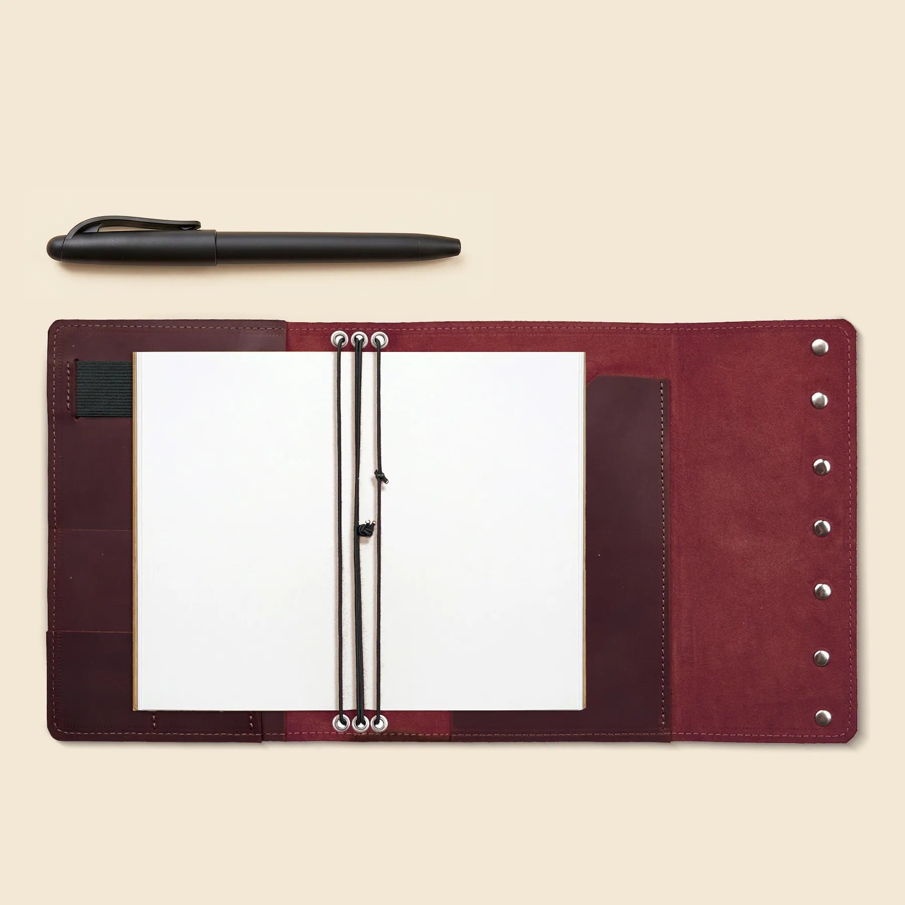 Genuine leather notebook cover with pen holder and organizer pockets inside.