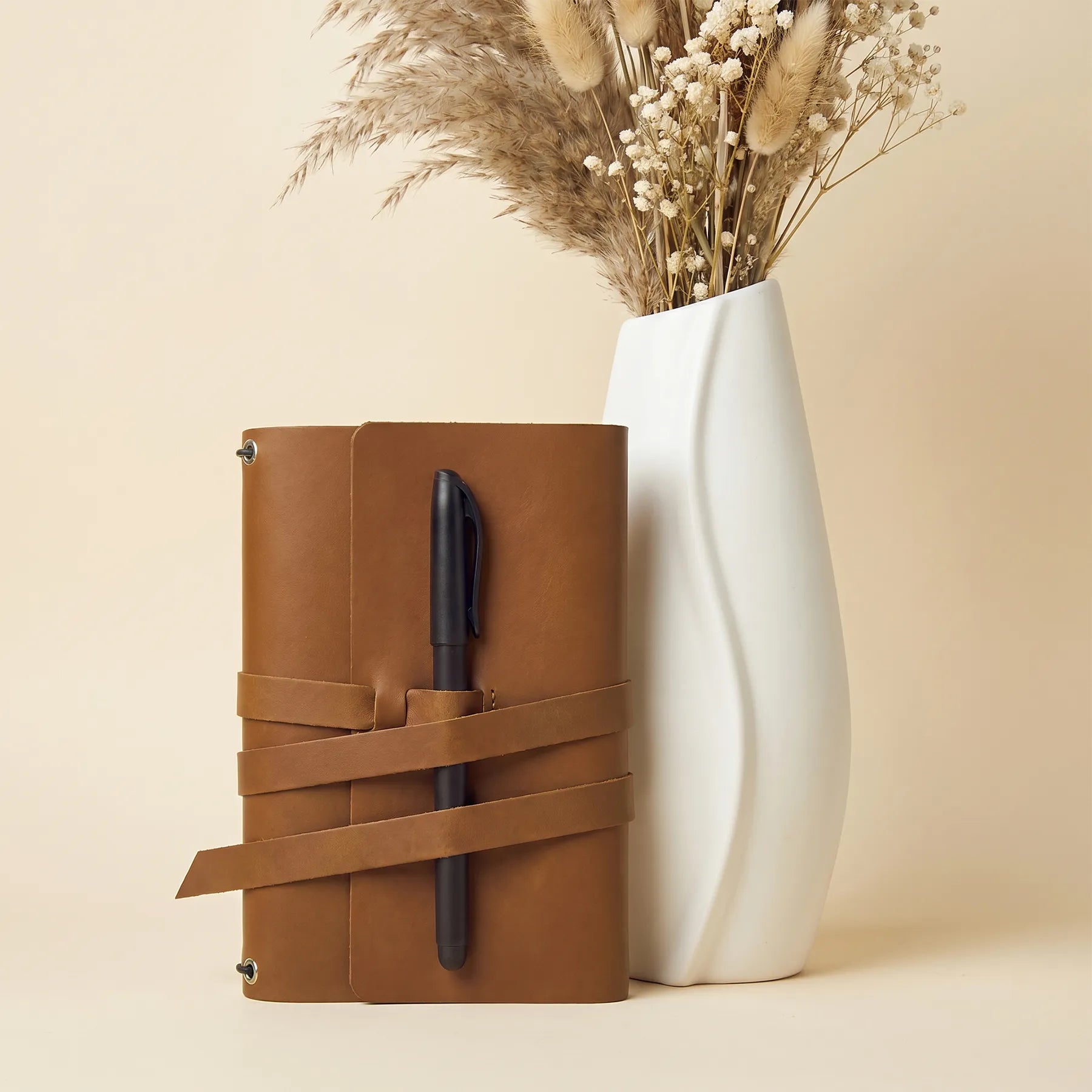 Genuine leather notebook cover with built-in pen holders for everyday organization and writing.