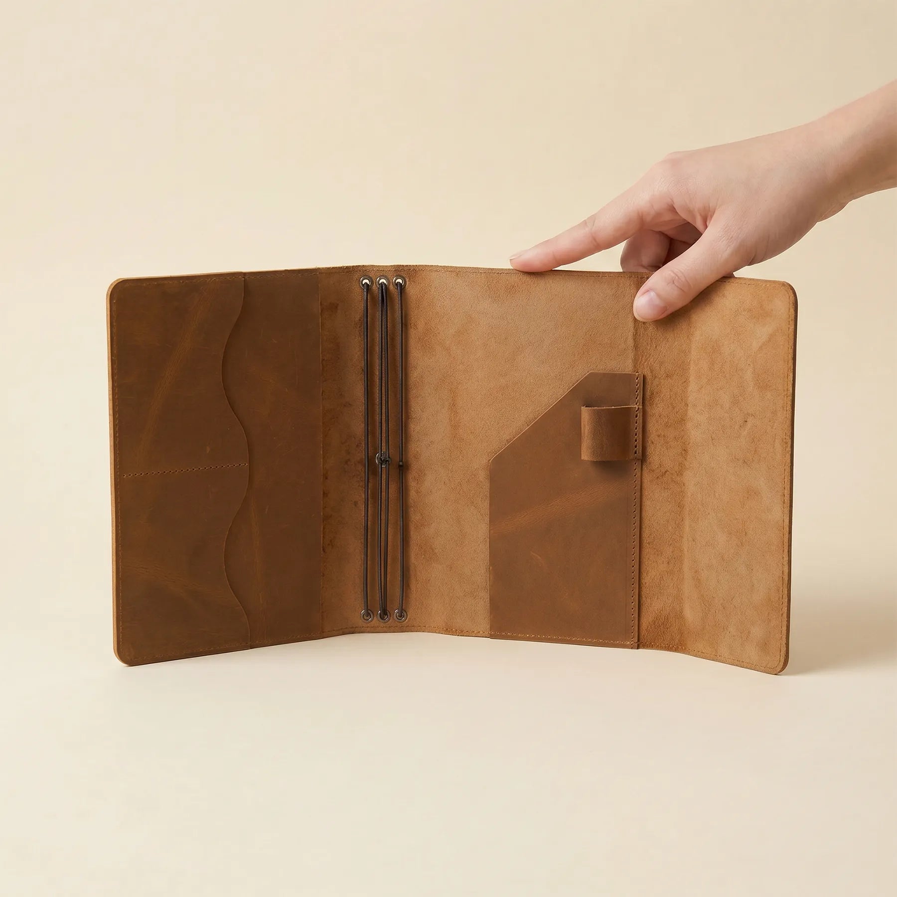 Leather travel notebook cover with interior slots and pen holder.
