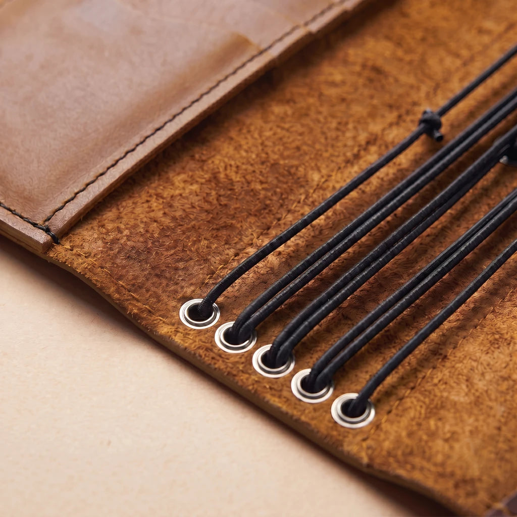 Compact leather notebook cover with efficient storage and pen access
