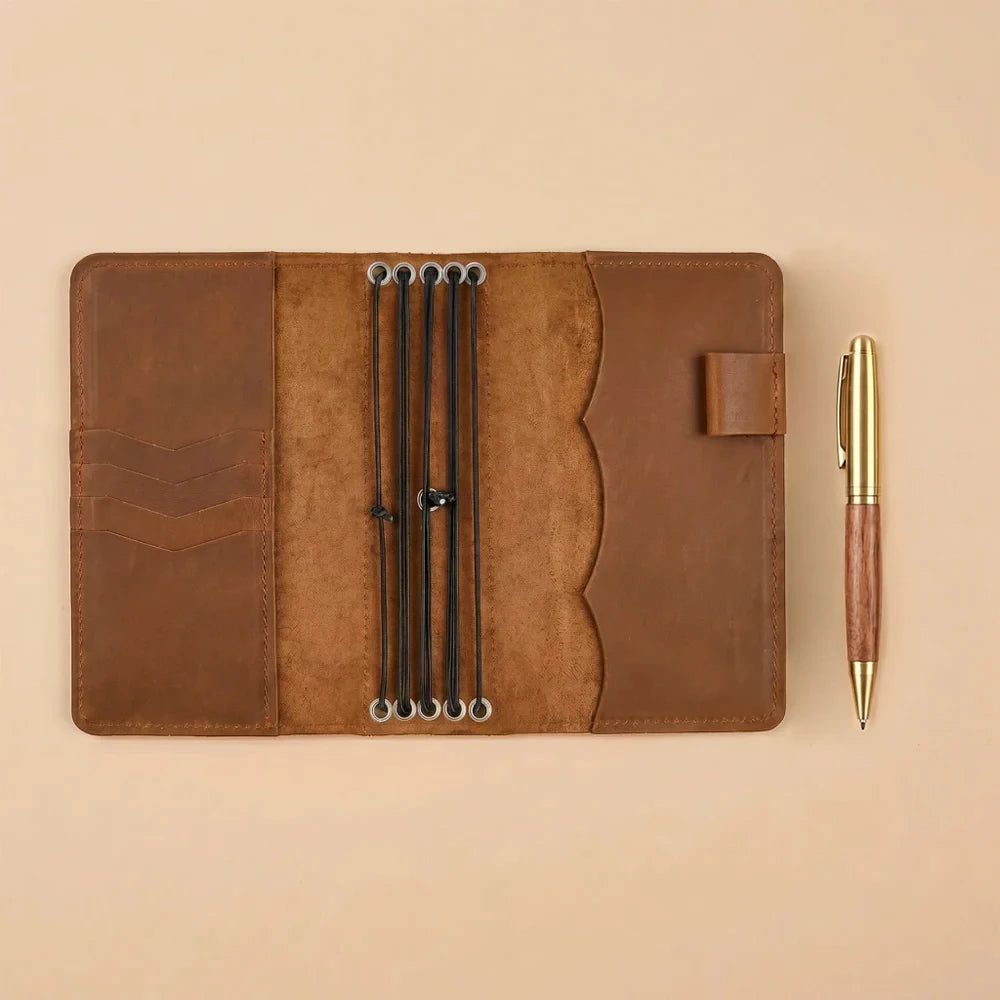 Handmade genuine leather notebook cover with elastic bands and interior storage pockets.