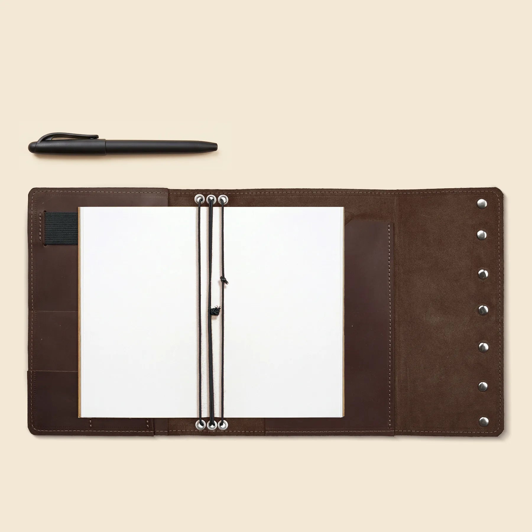 Premium refillable journal cover with pen loop and storage pockets.
