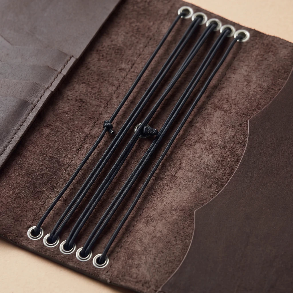 Minimalist leather notebook organizer with pen loop and storage pockets