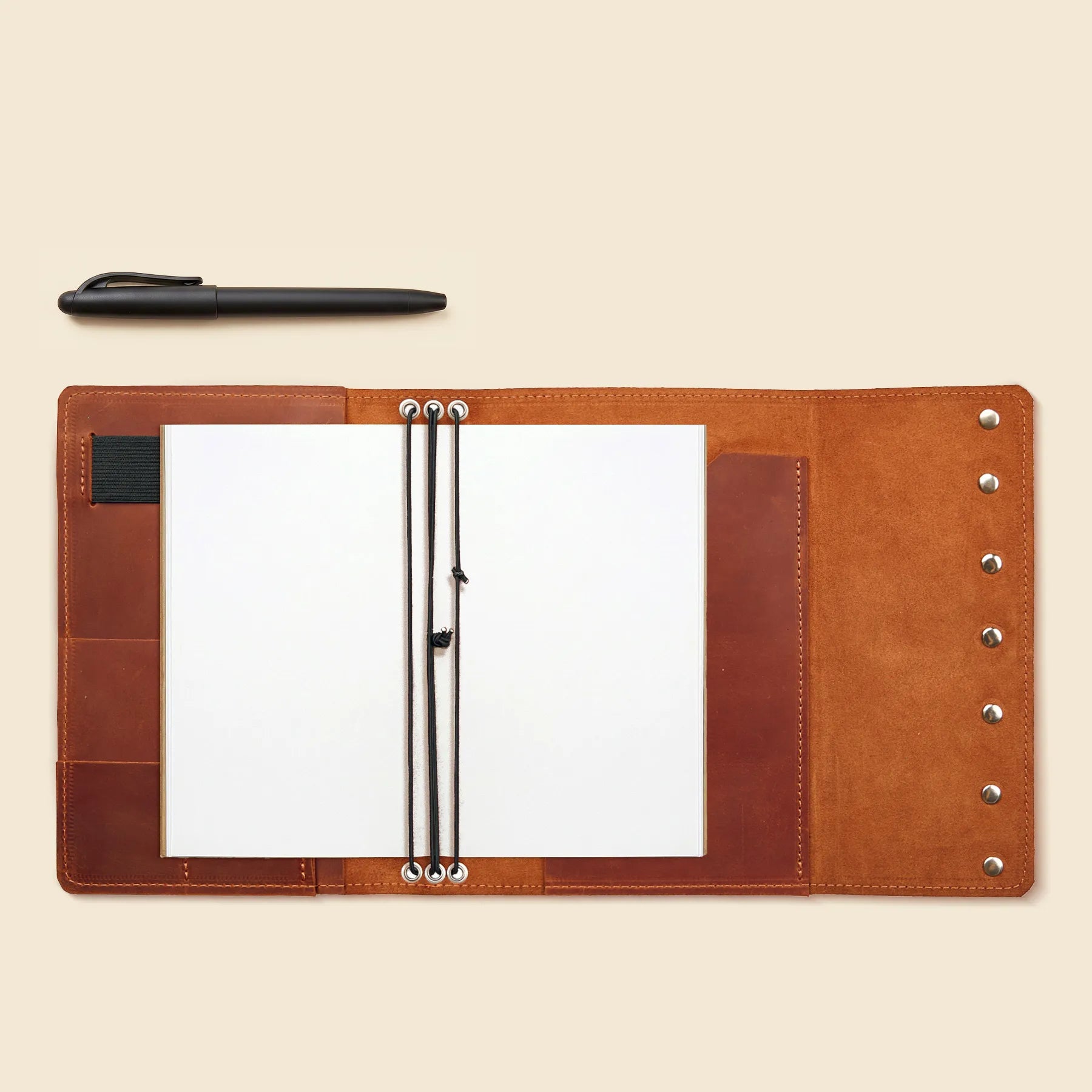 Stylish leather notebook cover with elastic inserts and card compartments.